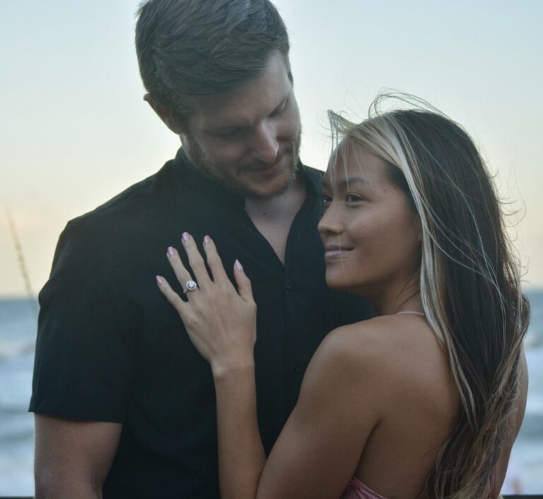 A couple embracing and showing an engagement ring — relationships in your 30s