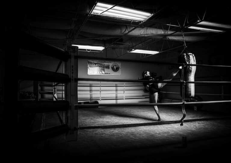 Black-and-white empty boxing ring in a gym — kickboxing in your 30s