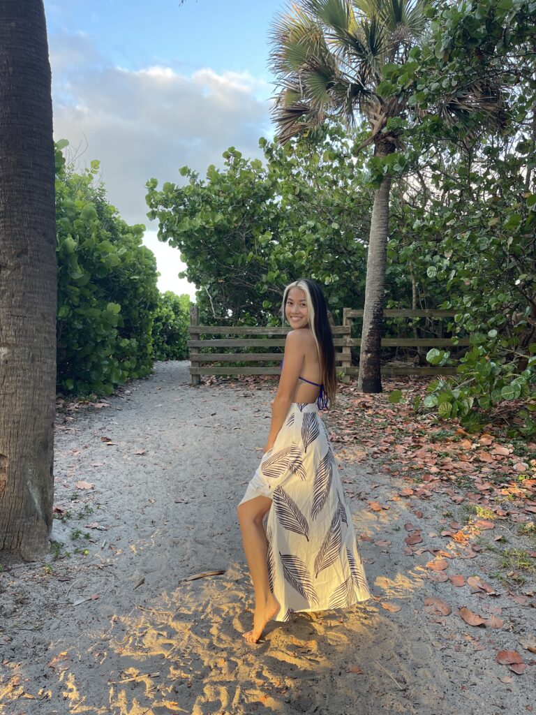 Woman walking down a wooded path โ mindful living in your 30s