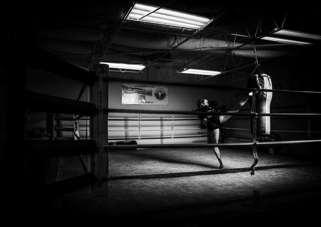Empty boxing ring in a gym, black and white