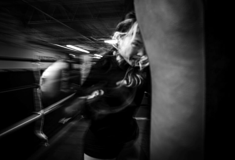 Black and white photo of a woman kickboxing