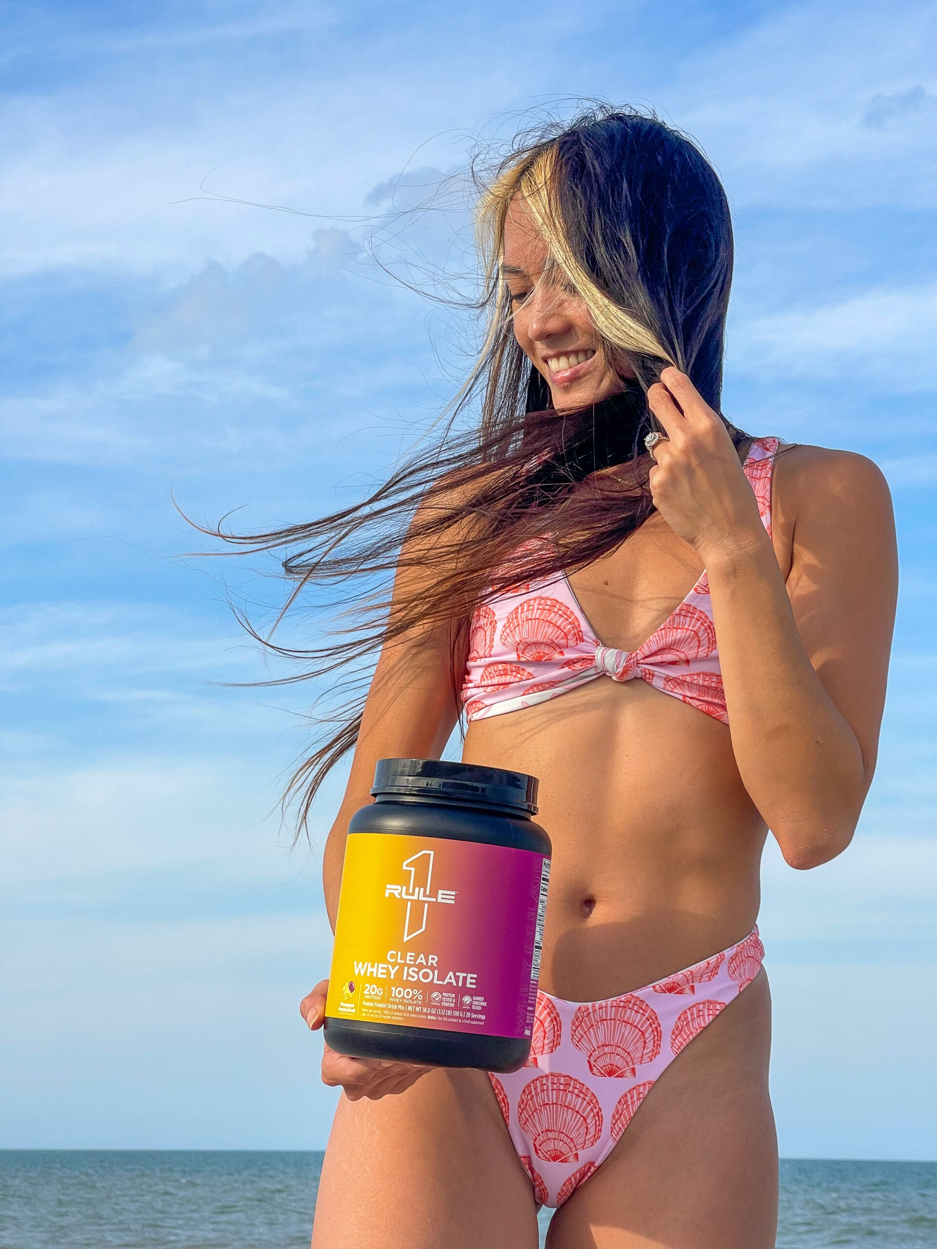 Lizzie smiling on the beach with protein
