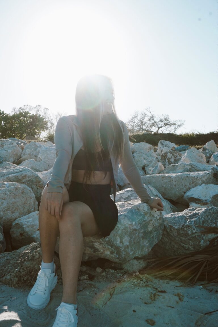 Woman by the rocks at the beach