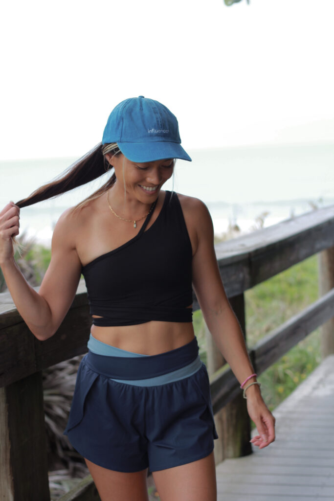 Lizzie in a blue cap on the boardwalk, thinking it over