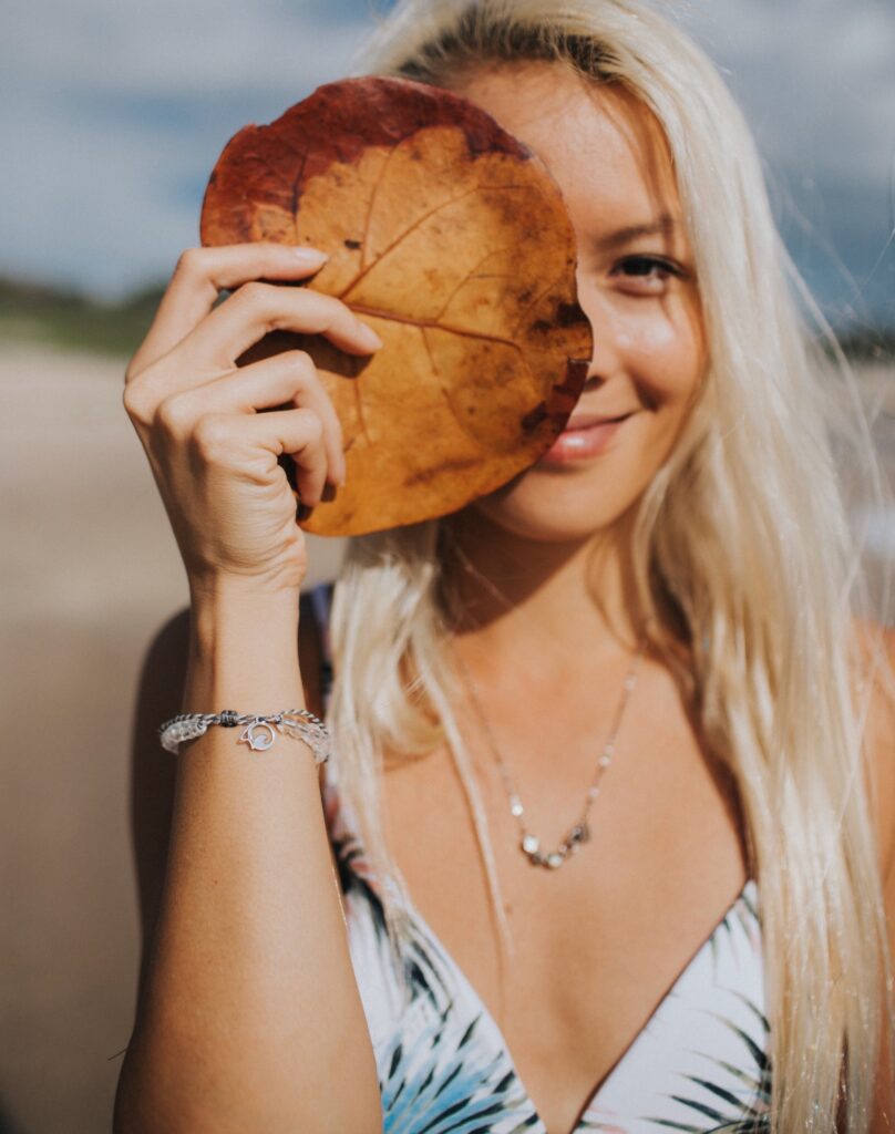 Beach portrait holding a sea grape leaf