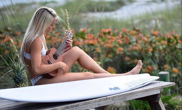 Playing guitar on a paddleboard on the water