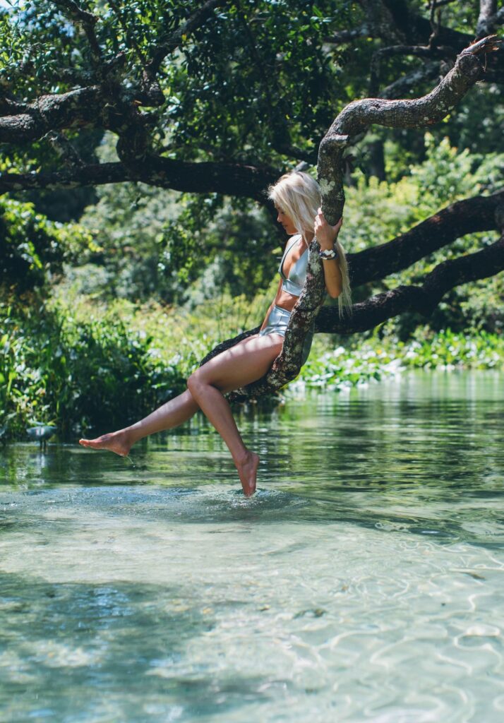 Swinging from a tree branch over a Florida spring