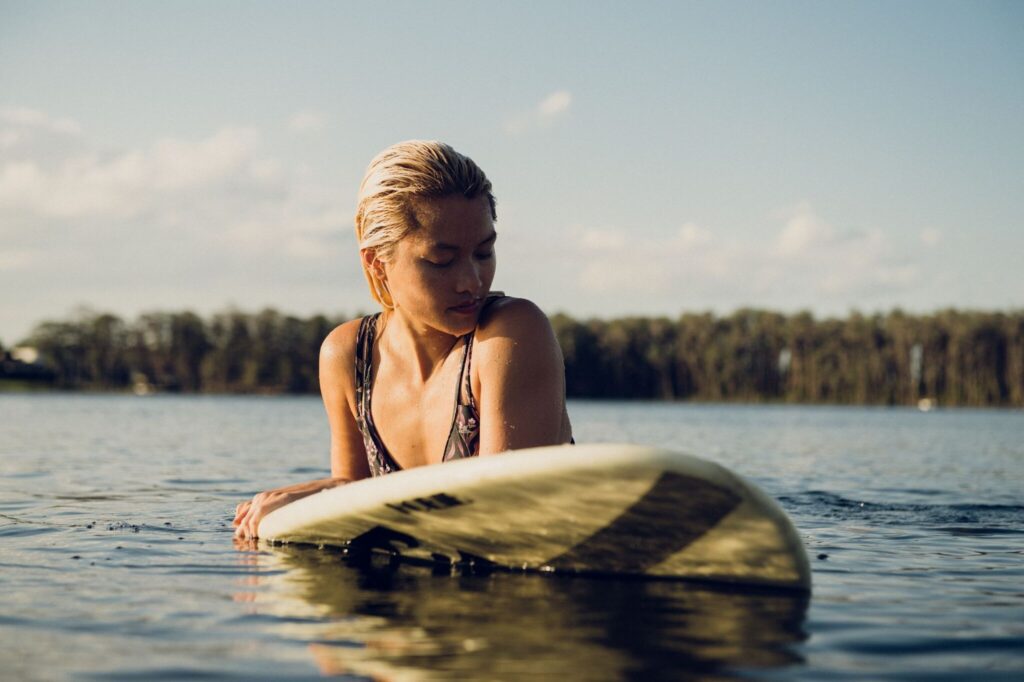 Resting on a surfboard at sunset