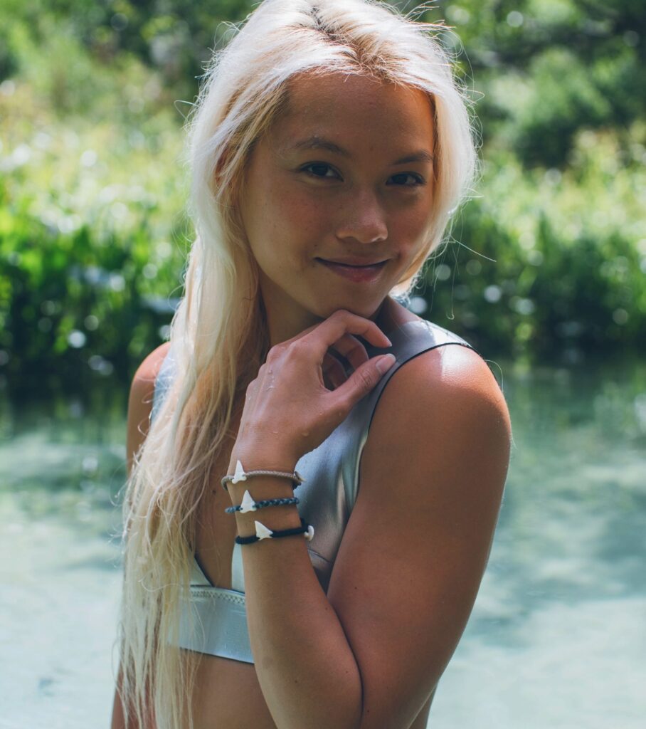 Portrait in a silver swimsuit by the water
